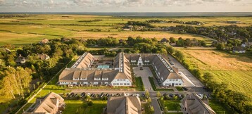 Terrain top view of the grounds of the Hotel Severin*s Resort & Spa and the Sylt coast by drone